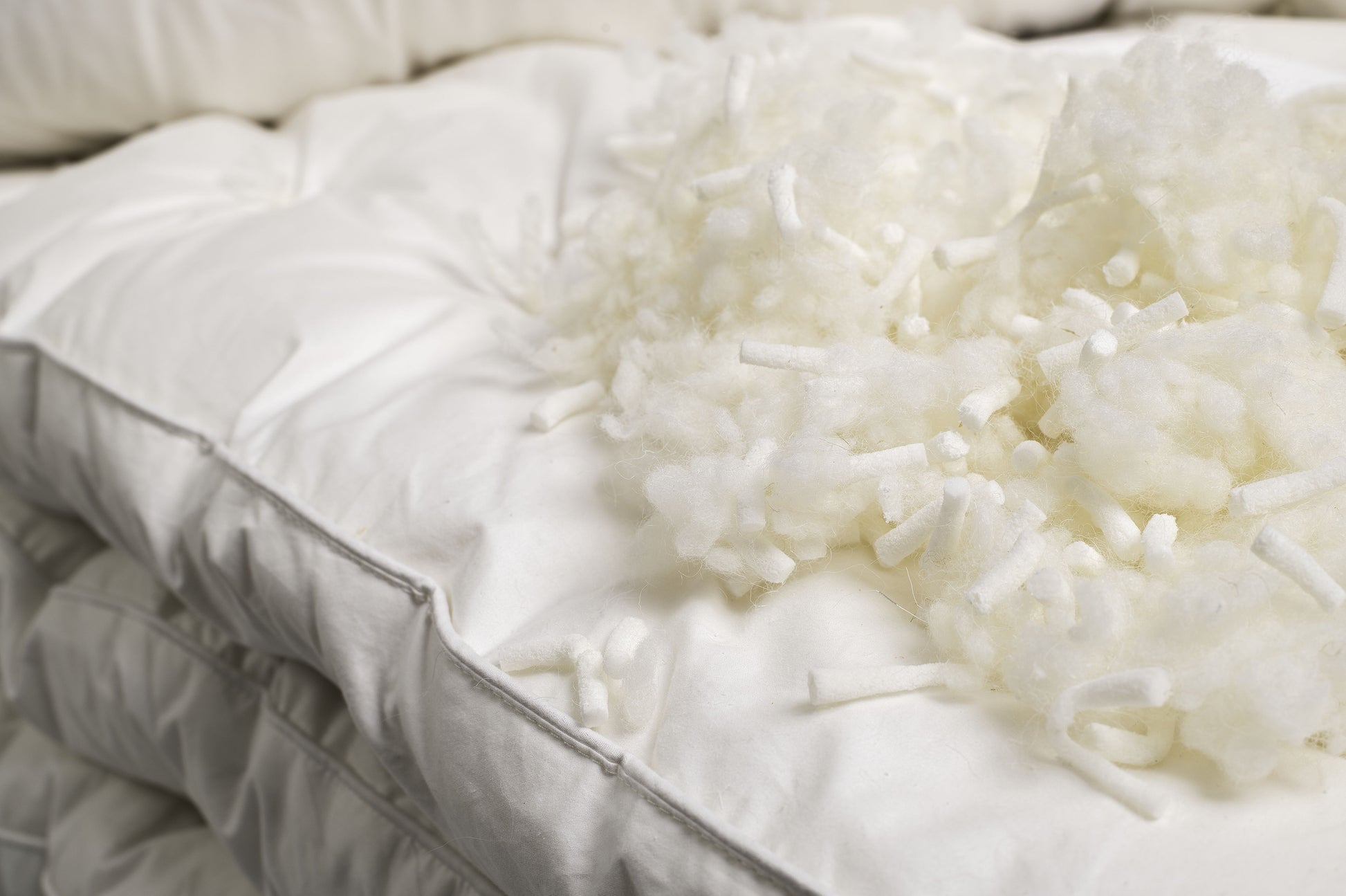 A close up picture of the shredded latex and wool used inside of the Sleep&Beyond myWooly Latex Topper.