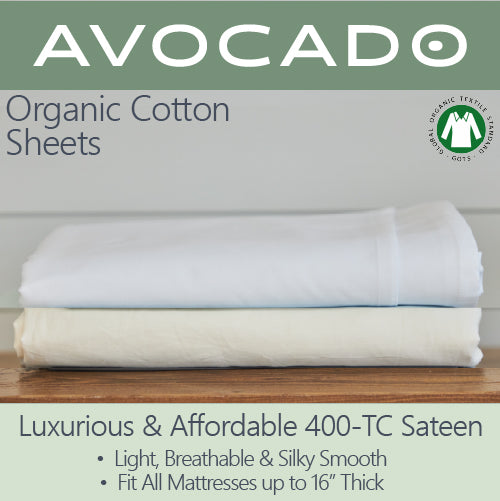 Picture of two Avocado Organic Cotton Sheets stacked on top of each other. The one on top is an ivory white color, and the one underneath it is a cream color. Luxurious and affordable 400-TC sateen. Light, breathable and silky smooth. Fir all mattresses up to 16" thick.
