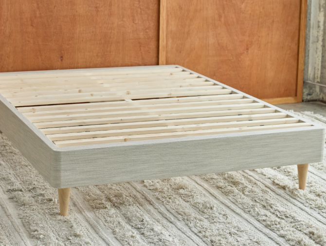 A picture of the Avocado Foundation assembled with wooden legs. The foundation has numerous slats running the entire width of the foundation to provide ample support for your mattress. The wood color of the leg is shown in a Blonde finish.